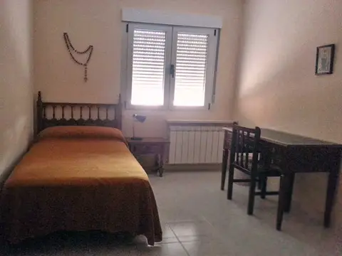 habitación individual de la casa, con cama, mesa y calefacción