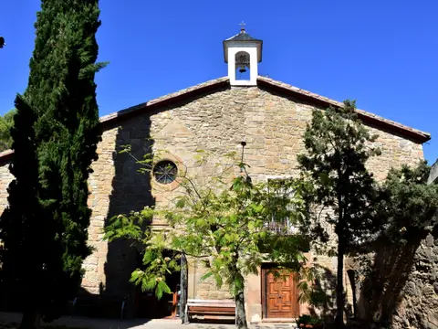 iglesia del santuario con su espadaña, entre cipreses