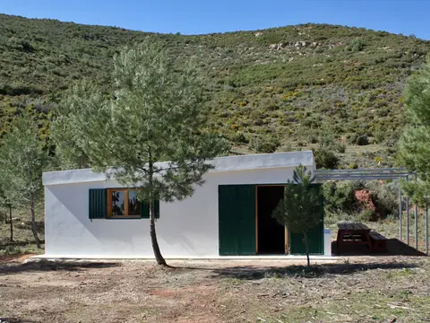 refugio con mesa de picnic exterior, entre matorral de la Calderona